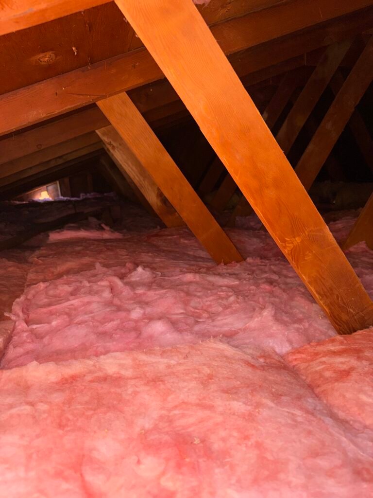 New pink fiberglass insulation installed in an attic by Atticity in the Bay Area, California